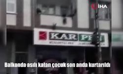 Balkonda asılı kalan çocuk son anda kurtarıldı