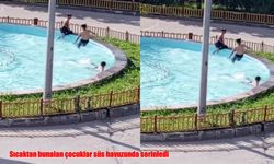 Sıcaktan bunalan çocuklar süs havuzunda serinledi